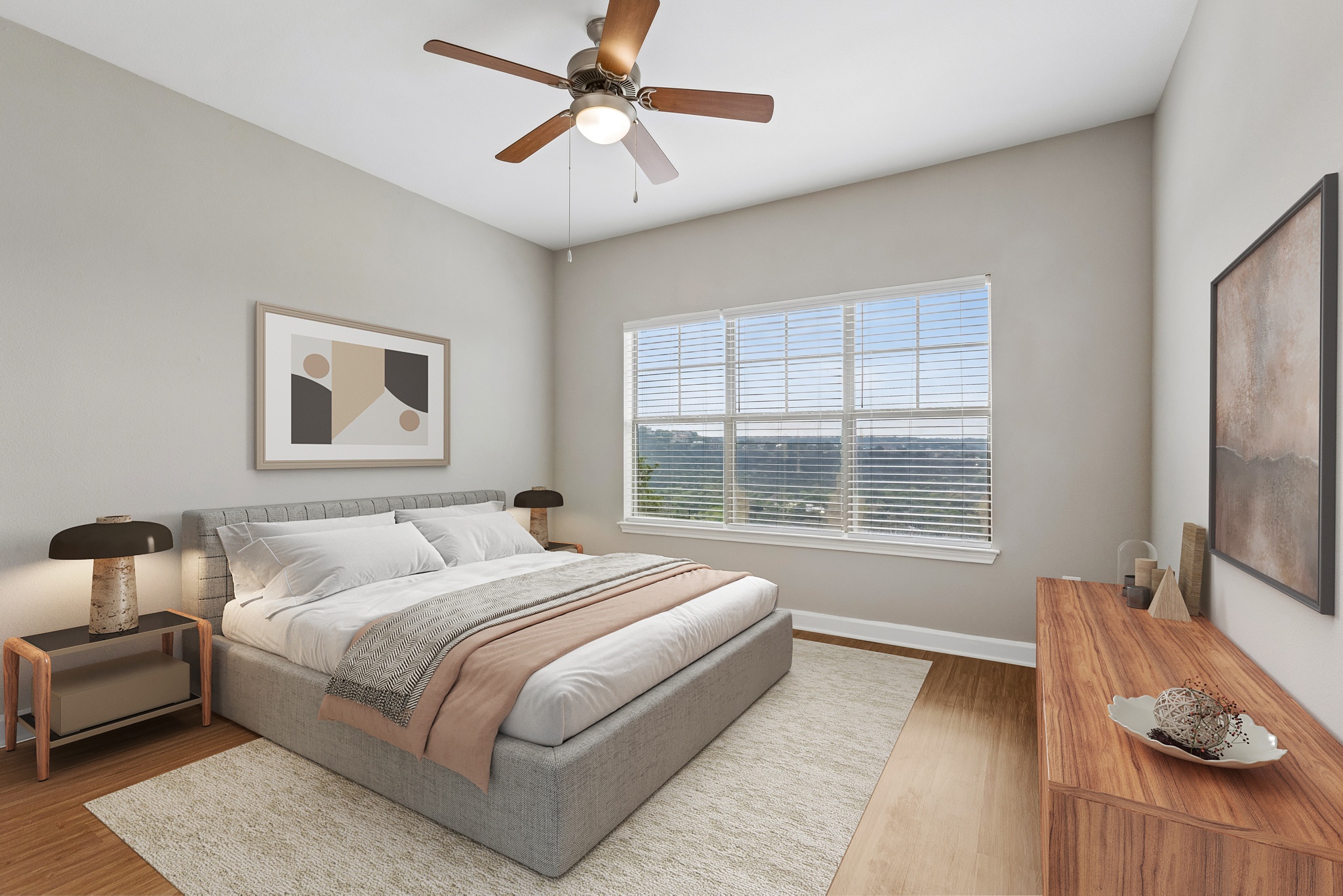 A bedroom with a bed, nightstand, and a ceiling fan.